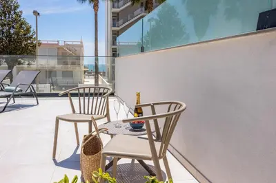 two chairs and a table on a balcony at Terraços de Quarteira Green by Real Properties in Quarteira