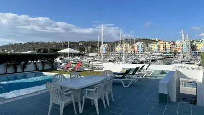 a patio with a table and chairs next to a marina at Marina by Check-in Portugal in Albufeira
