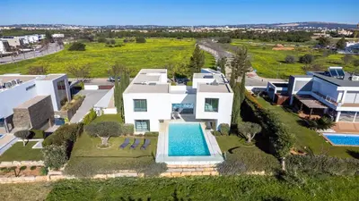 an aerial view of a house with a swimming pool at Villa BEA - Clever Details, Luxury, Golf views, Sleeps 10 in Vilamoura