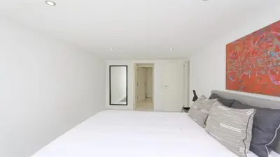 a white room with a bed and a painting on the wall at Villa BEA - Clever Details, Luxury, Golf views, Sleeps 10 in Vilamoura