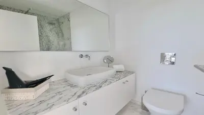 a white bathroom with a sink and a toilet at Villa BEA - Clever Details, Luxury, Golf views, Sleeps 10 in Vilamoura