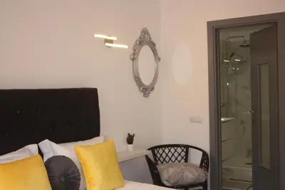 a bedroom with a bed and a mirror on the wall at Yucca in Faro