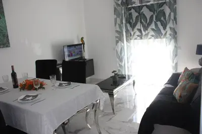 a living room with a table and a couch at Yucca in Faro