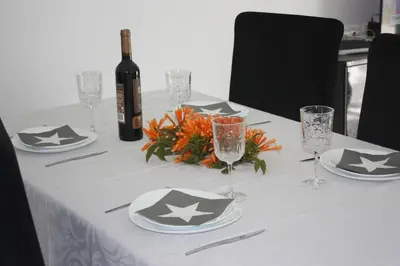 a table with a bottle of wine and plates and glasses at Yucca in Faro
