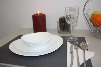 a table with a candle and a bowl and a plate at Yucca in Faro