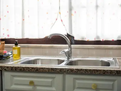 a stainless steel sink in a kitchen with a window at Villa Dogueno by Stay ici Algarve Holiday Rental in Albufeira