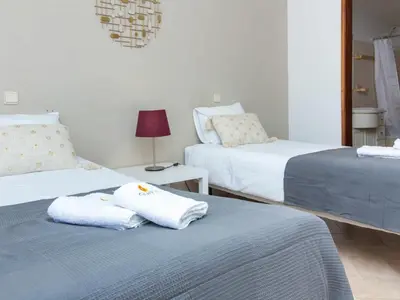 a bedroom with two beds with towels on them at Villa Dogueno by Stay ici Algarve Holiday Rental in Albufeira