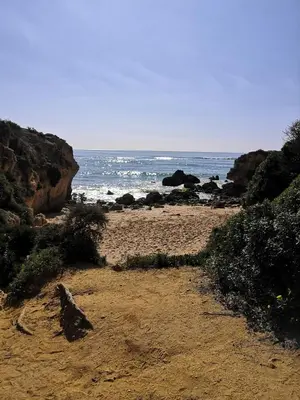 a sandy beach with the ocean in the background at Central Albufeira 2-B Apt Sleeps 6 Pool Parking in Areias Sao Joao