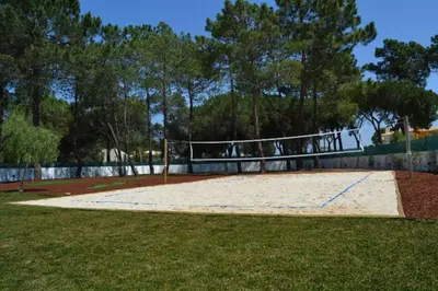 a volleyball court in the middle of a field at 8-Bed Villa in Vilamoura-Sleeps-Playground-Pool in Vilamoura