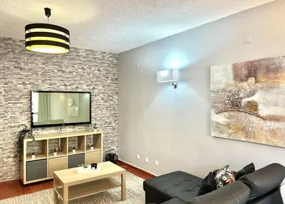 a living room with a couch and a tv at Marina Jardim - Vilamoura Marina by HD Properties in Vilamoura
