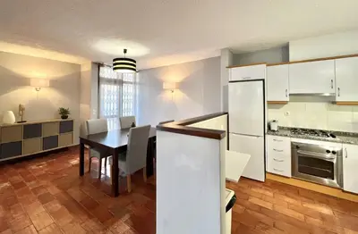 a kitchen and dining room with a table and chairs at Marina Jardim - Vilamoura Marina by HD Properties in Vilamoura