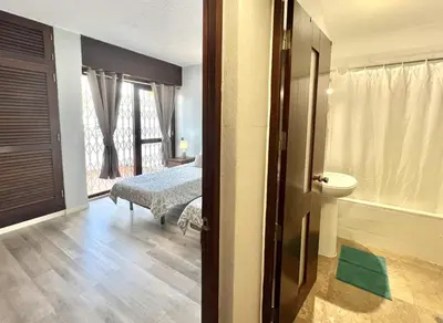 a room with a bedroom with a bed and a bathroom at Marina Jardim - Vilamoura Marina by HD Properties in Vilamoura