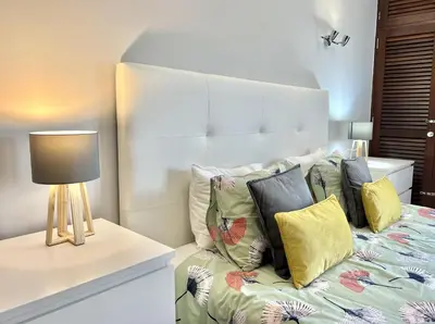 a bedroom with a bed with pillows and a lamp at Marina Jardim - Vilamoura Marina by HD Properties in Vilamoura