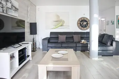a living room with a couch and a table at Villa Stefy by Bedzy in Galé