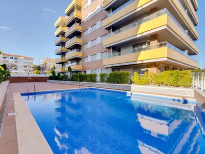 a swimming pool in front of a building at AL - Apartamento Carteia in Quarteira