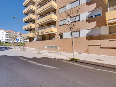 an empty street in front of a building at AL - Apartamento Carteia in Quarteira
