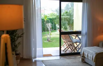 a room with a door open to a patio with a chair at Oura 7 in Albufeira