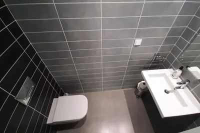 a bathroom with a white toilet and a sink at Panoramic View Apartment in Albufeira