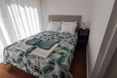 a bedroom with a bed with two computers on it at Panoramic View Apartment in Albufeira