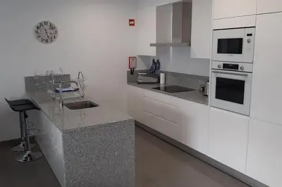 a kitchen with white cabinets and a counter top at Panoramic View Apartment in Albufeira