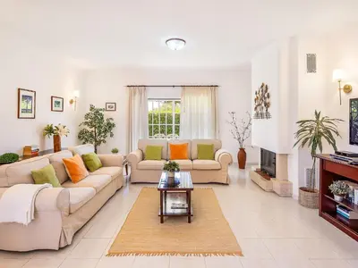 a living room with two couches and a fireplace at Vila Montejunto in Albufeira
