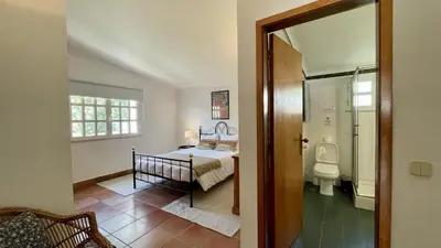 a bedroom with a bed and a bathroom with a toilet at Espraguina by Check-in Portugal in Loulé