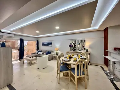 a kitchen and living room with a table and chairs at Vilamoura Marina Mar 2 With Pool by Homing in Vilamoura