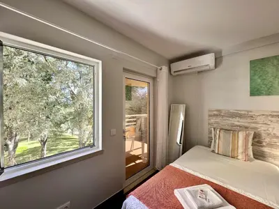 a bedroom with a bed and a large window at Vilamoura Marina Mar 2 With Pool by Homing in Vilamoura