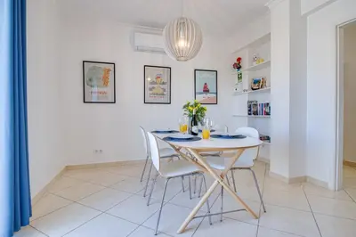 a dining room with a white table and chairs at Old Town 2BR 50m Ocean w/ AC Wi-Fi Parking Terrace in Albufeira