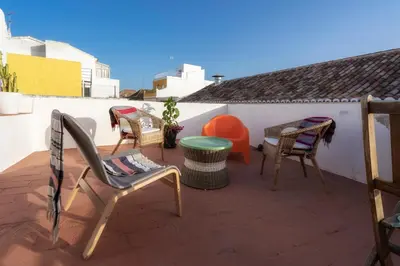 a patio with chairs and a table on a balcony at Downtown Lady Terrace in Faro
