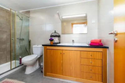 a bathroom with a toilet and a sink and a shower at Downtown Lady Terrace in Faro