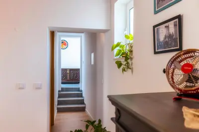 a hallway with a staircase and a room with white walls at Downtown Lady Terrace in Faro