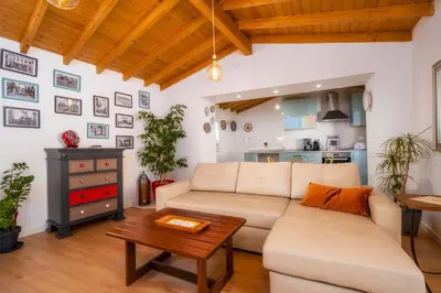 a living room with a white couch and a table at Downtown Lady Terrace in Faro