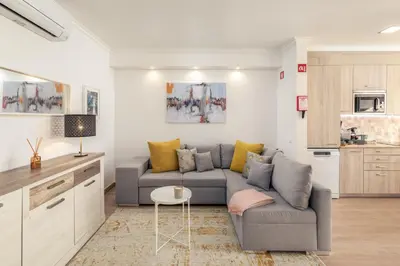 a wooden dresser with two lamps on top of it at Apartamento Sunset on the Sea in Albufeira