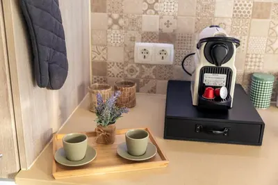 a kitchen with wooden cabinets and a sink and a window at Apartamento Sunset on the Sea in Albufeira