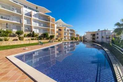 a swimming pool in front of a apartment building at by blen.d in Albufeira