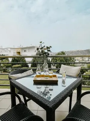a table with glasses on it on a balcony at by blen.d in Albufeira