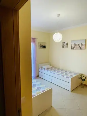 a bedroom with two beds and a window at by blen.d in Albufeira