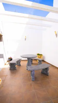 a table and two benches in a room at Ocean View Villa in Boliqueime