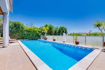 a swimming pool in the backyard of a house at Ocean View Villa in Boliqueime