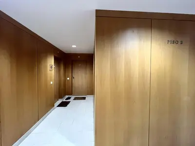 a hallway with wooden doors and a white tile floor at Albufeira Modern 4 With Pool by Homing in Albufeira