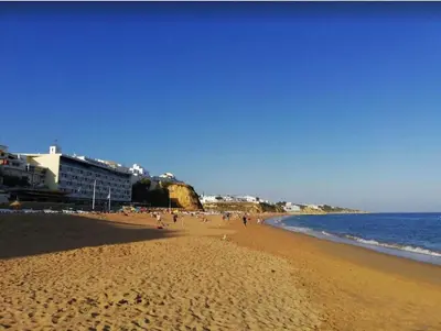 a group of people on a beach near the water at Spacieux Appartement Logis des Fées de la Marina en rez-de-chaussée de chaussée in Albufeira