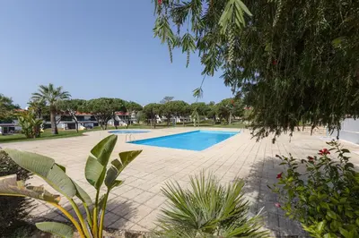 a swimming pool in the middle of a yard at VILASOL - 