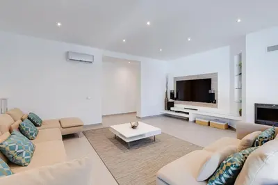 a living room with a flat screen tv at VILLA LIMOEIRO - Beautiful new home nestled in the heart of Galé in Guia