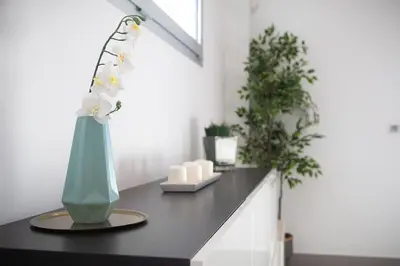 a large long table in a room with white walls at VILLA LIMOEIRO - Beautiful new home nestled in the heart of Galé in Guia