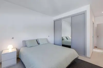 a white bedroom with a bed and a window at VILLA LIMOEIRO - Beautiful new home nestled in the heart of Galé in Guia