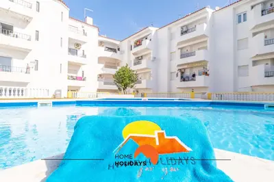 a swimming pool in front of a building at #112 Oura Flat by Home Holidays in Albufeira