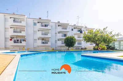 a swimming pool in front of a building at #112 Oura Flat by Home Holidays in Albufeira