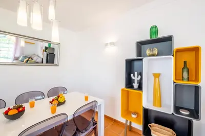 a dining room with a table and chairs and a tv at Beachsun Gale - beautiful villa close to beach in Galé