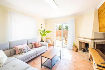 a living room with a couch and a fireplace at Villa Habitate - pool fence & heating beach bars in Albufeira